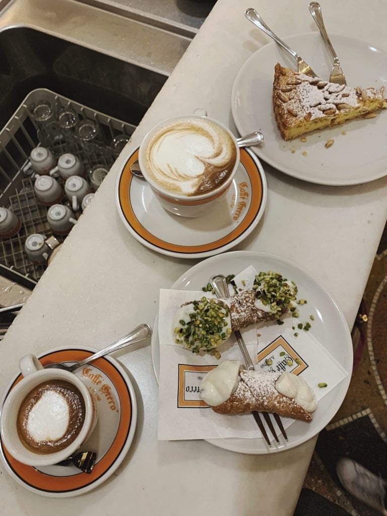 classic italian coffee with a few sicilian cannolo and a piece of cheesecake from cafe greco