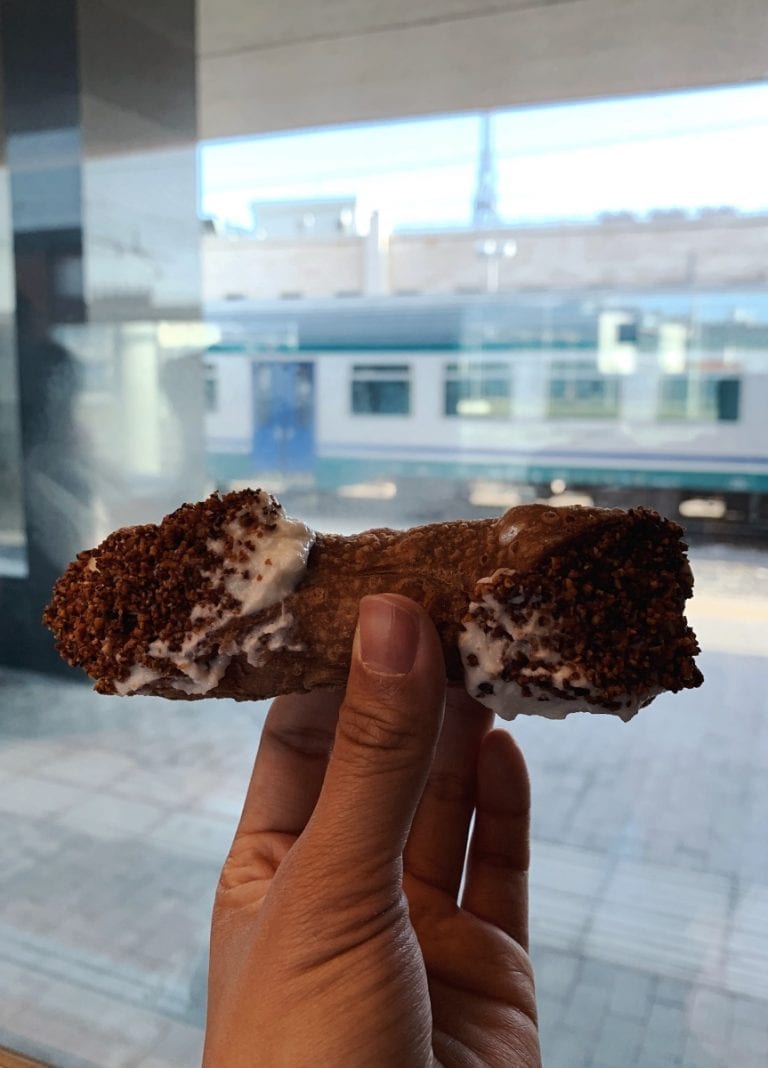 a traditional sicilian dessert cannolo with a lot of ricotta cheese and cacao powder