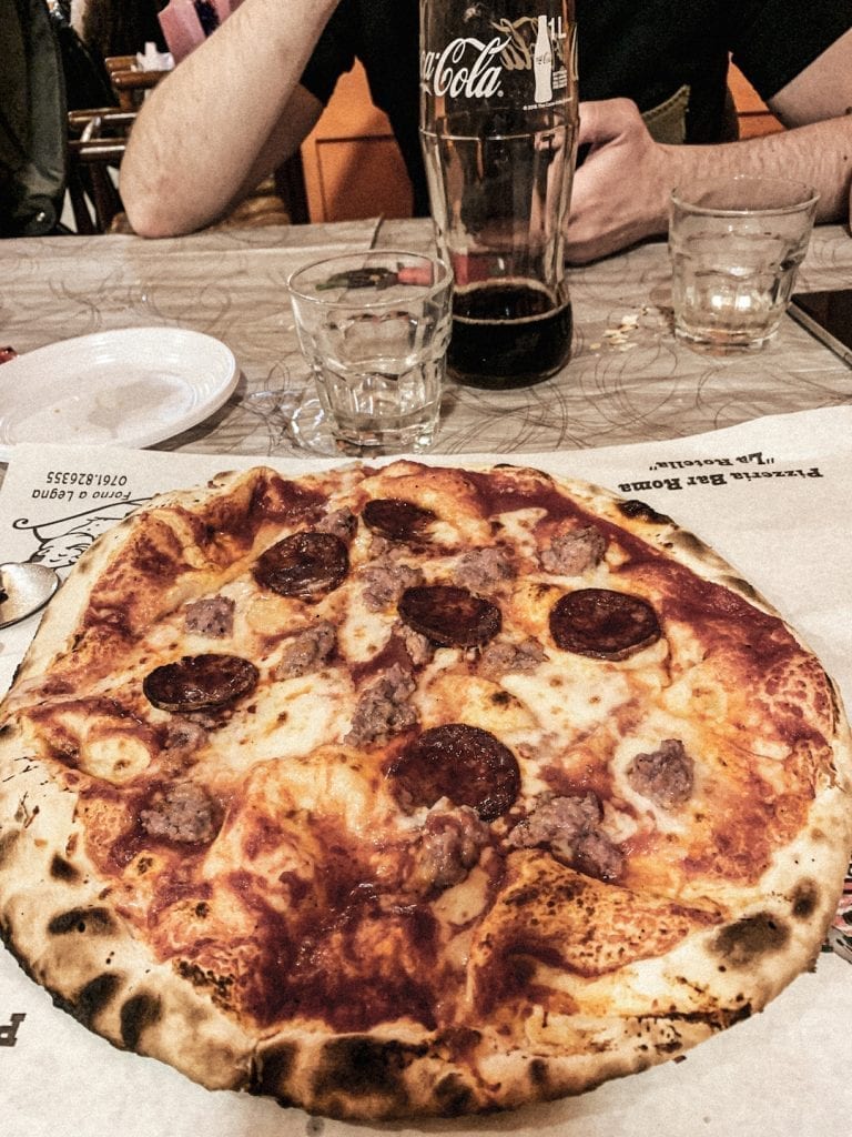 pizzeria la rotella of montefiascone serves their big pizza on the paper directly