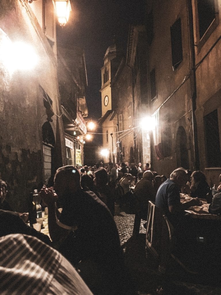 special summer wine festival and the local tradition of eating on the long benches on the street of old stone city in summer