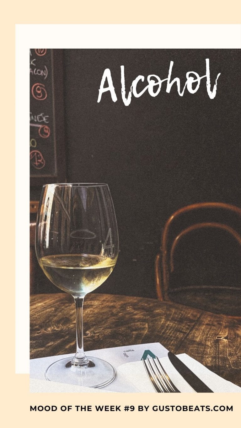 a glass of white wine on a beautiful wooden table in a restaurant in Rome