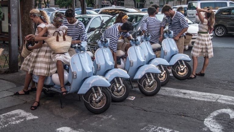 the beautiful italian girls and boys getting ready on a vespa ride