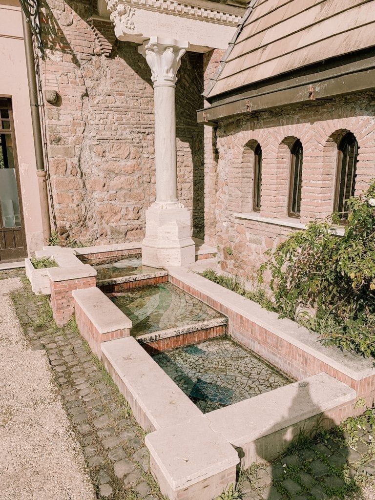 the house of owls has mini romanesque style columns and mini fountains