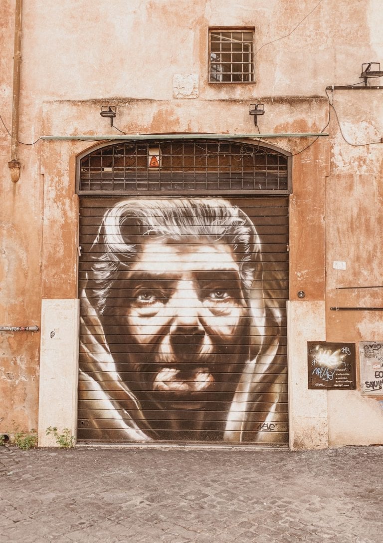 powerful and determined italian grandma graffiti on a shop roller shutter in trastever Rome
