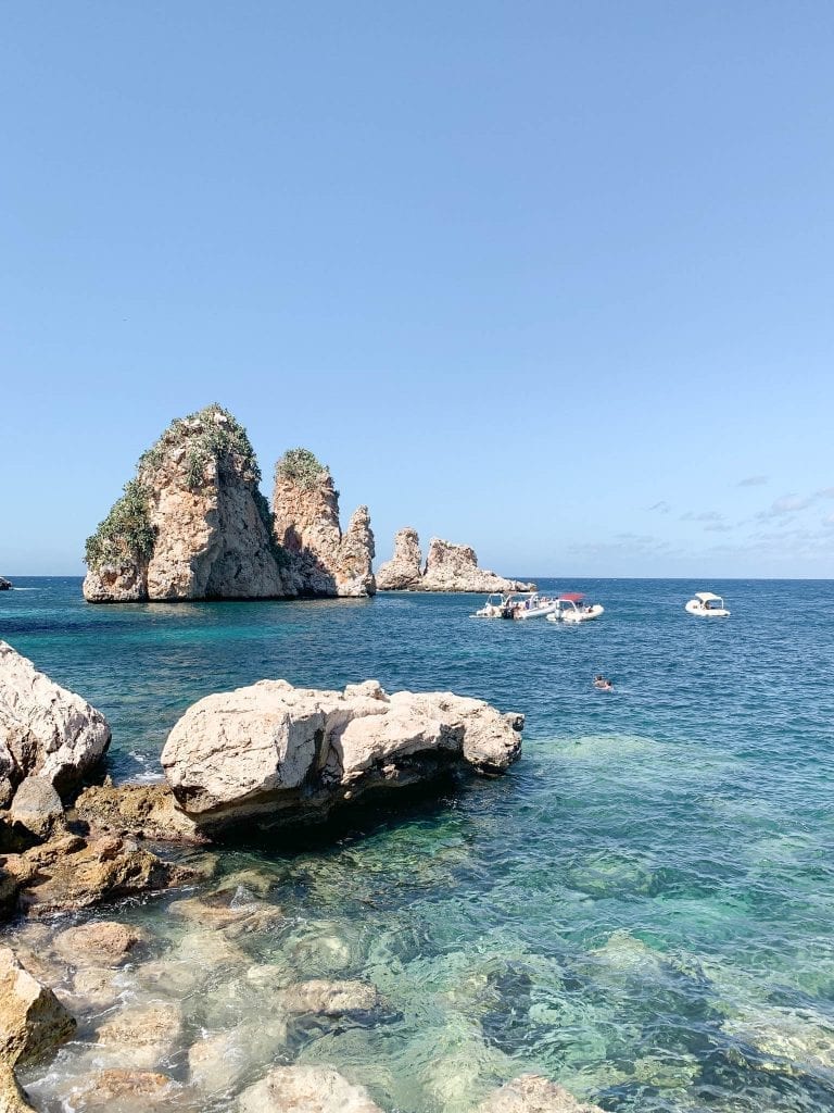 the stunning view with crystal clear water in different blues of tonnara di scopello