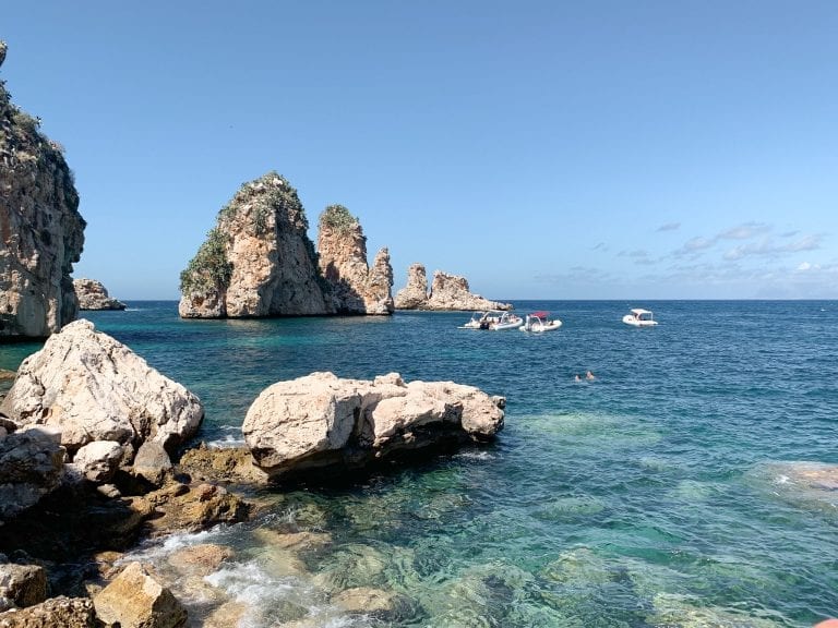 the stunning view with crystal clear water in different blues of tonnara di scopello