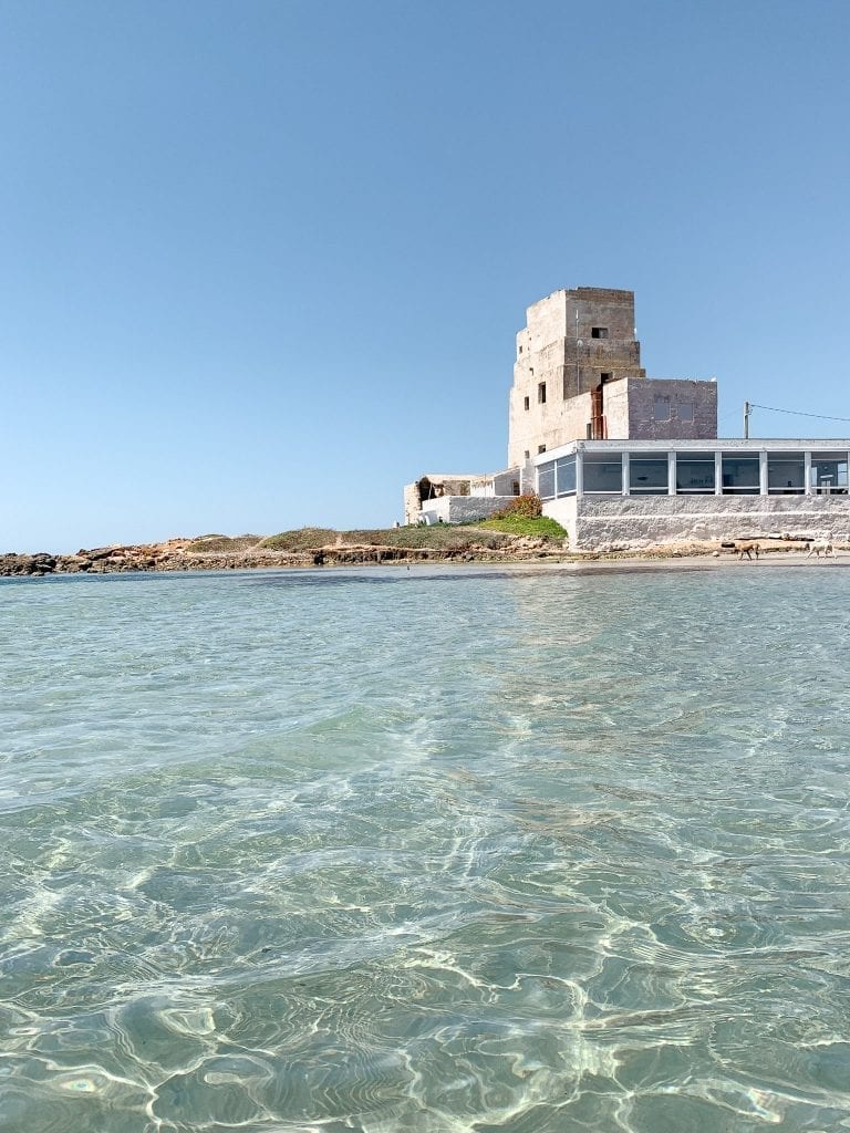 view of the torre di san teodoro from its crystal clear seawater