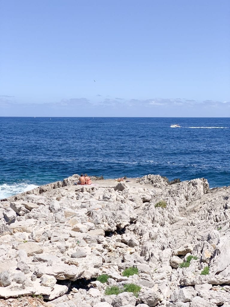 the locals chilling on the rocks at isola delle femmine