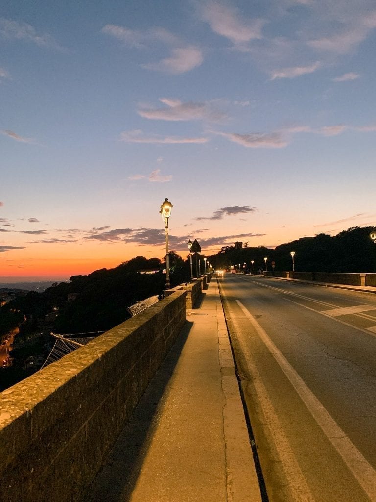 The sky is burning during Ariccia's summer sunset and the long bridge is the best spot to enjoy the view