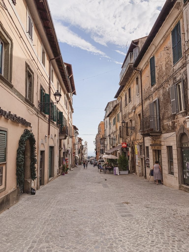 A stone street in Ariccia gives a nice view of the valley in the far end