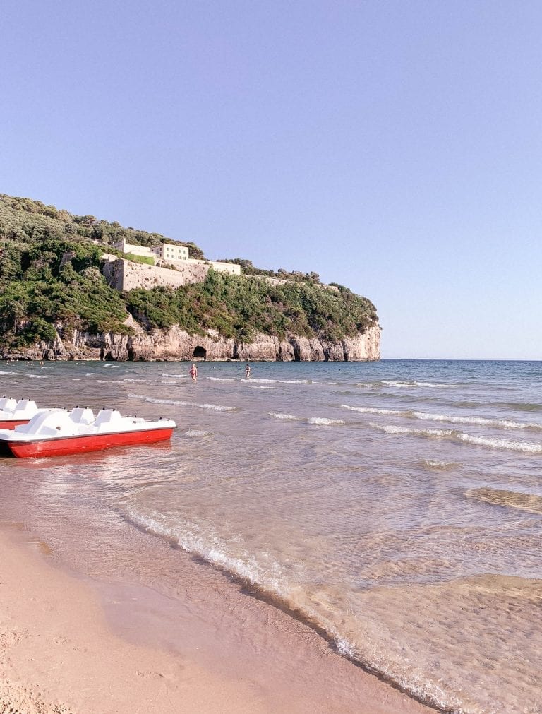 There is a cliff next to the Gaeta beach and in the seawater you can walk all the way till the root of the cliff and there are some caves too