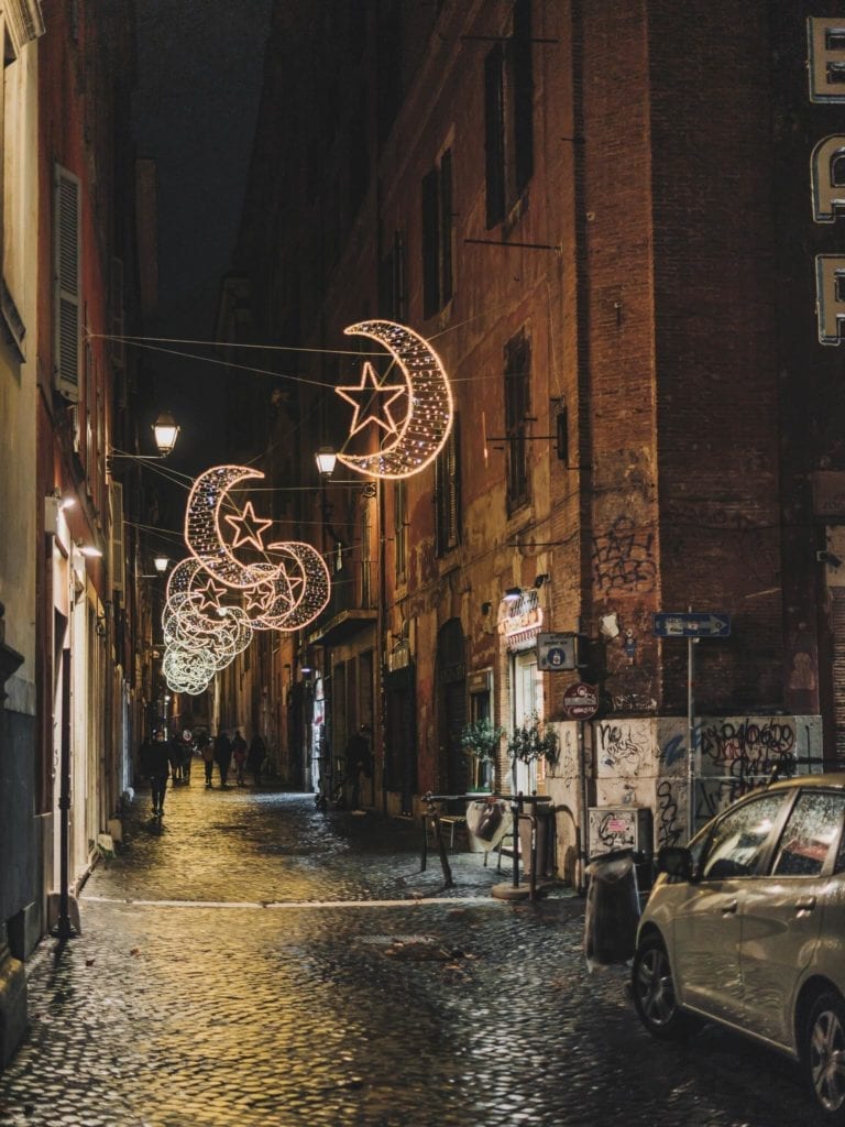 the cobble streets in rome in christmas nights is extra beautiful with those light decorations and it is the best time to enjoy a glass of hot vin brule as well
